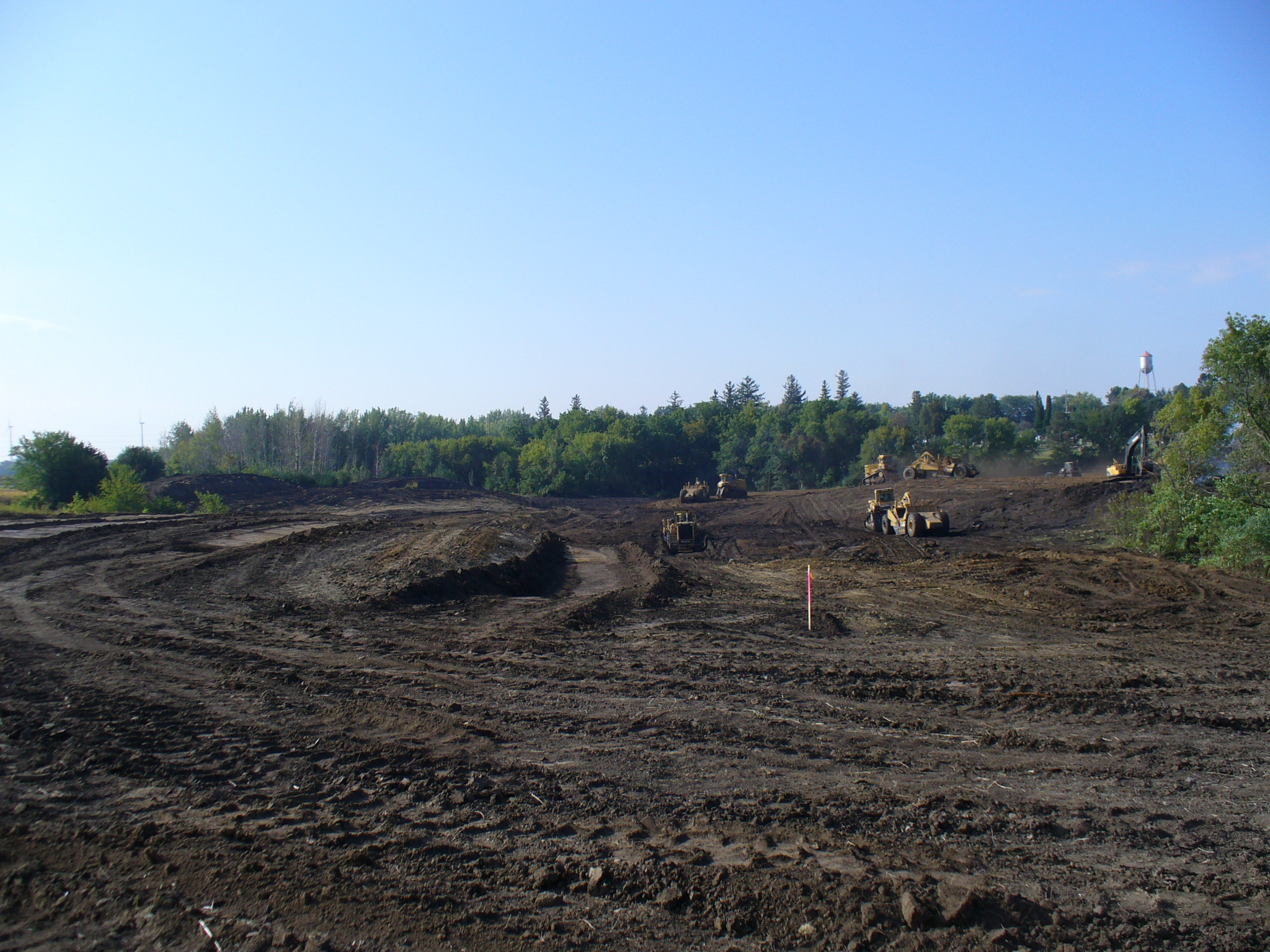 Looking southwest as dirt is removed from the bottom of the new lake and spread on the dam. September 23, 2013